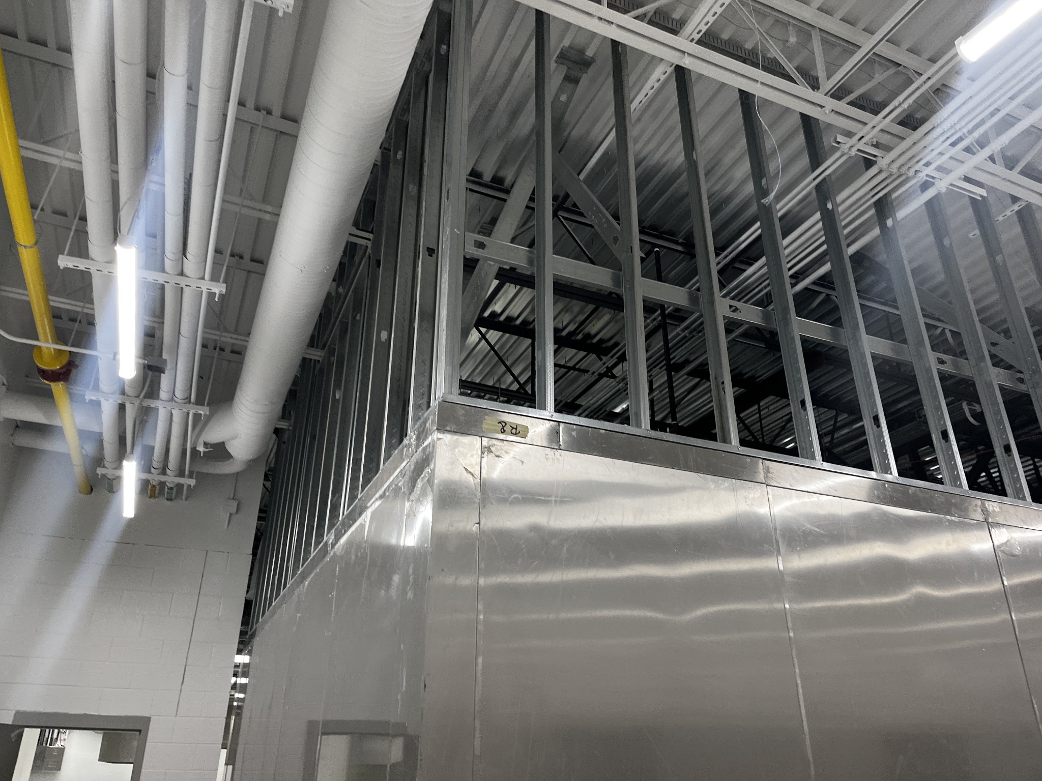 Metal stud walls and drywall installation in progress